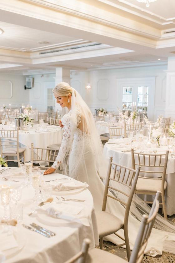 Bride admiring tables for wedding meal